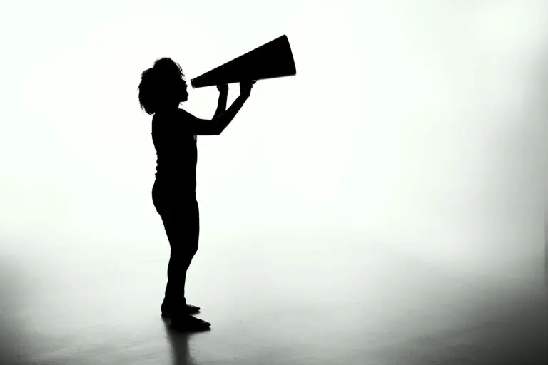 Silhouette of person shouting into a megaphone